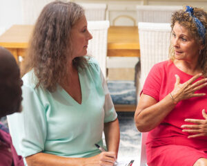 3 adults in a support group speaking