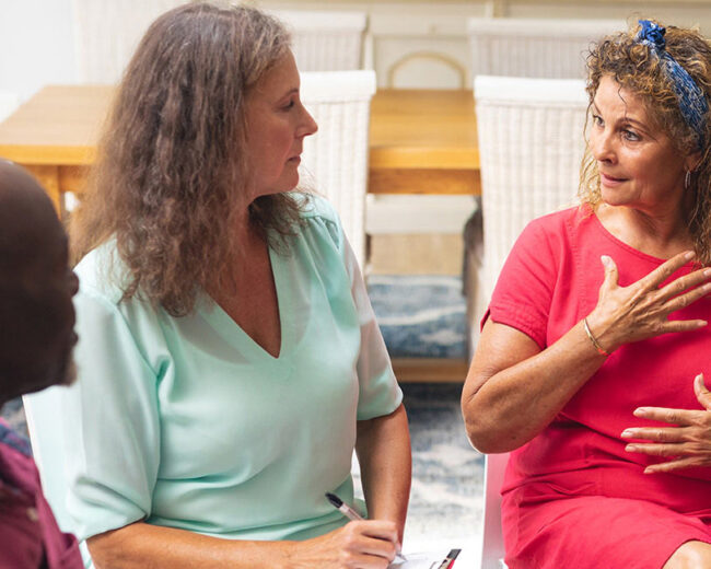 3 adults in a support group speaking