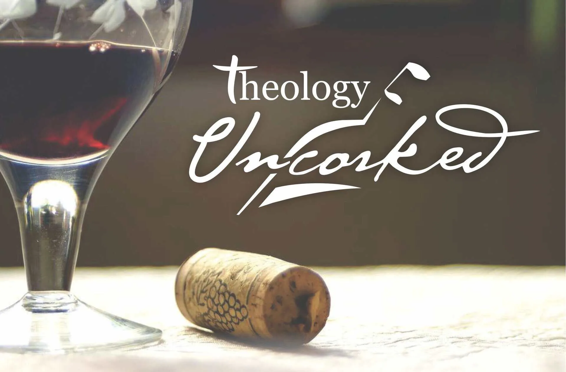 Theology Uncorked Theology Uncorked logo with a glass of red wine and cork on a wooden surface.